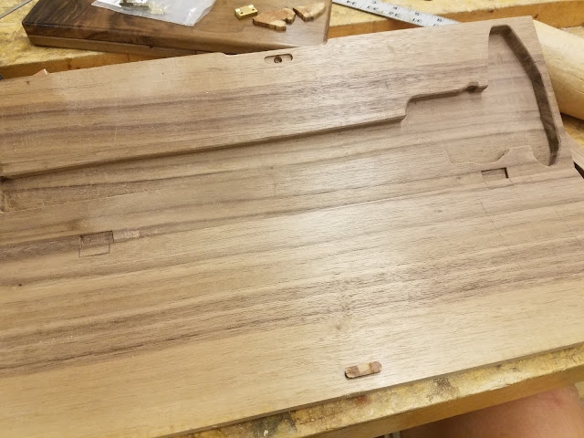 walnut board with pocket in the shape of callipers and pencil markings for planned hinge pockets