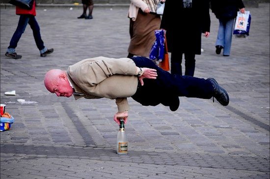 An old man doing acrobatic moves