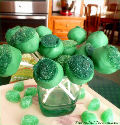 Chocolate Mint Cookie Pops, a no-bake treat. Mint cookie balls with a surprise inside. A fun dessert for St. Patrick’s Day or for any occasion | Recipe developed by www.BakingInATornado.com | #recipe #dessert #StPatricksDay
