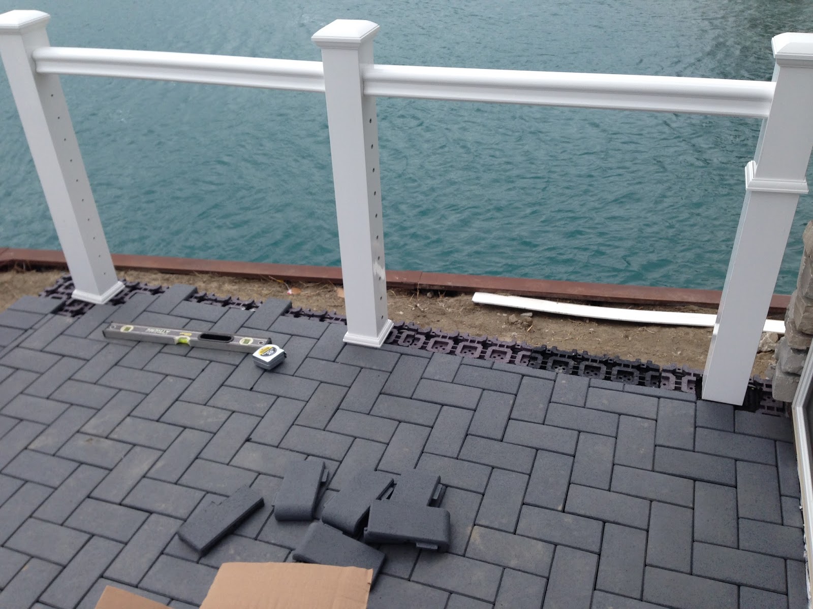 Outdoor Living Low sloped roof decks, composite pavers and cable rail.