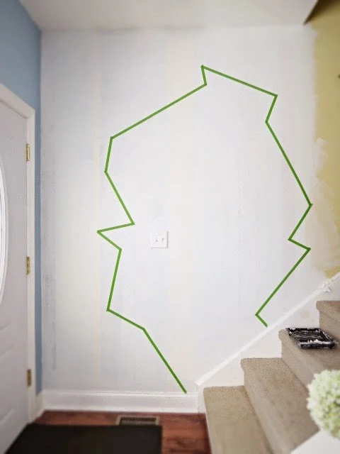 laying out the first round of tape on wall