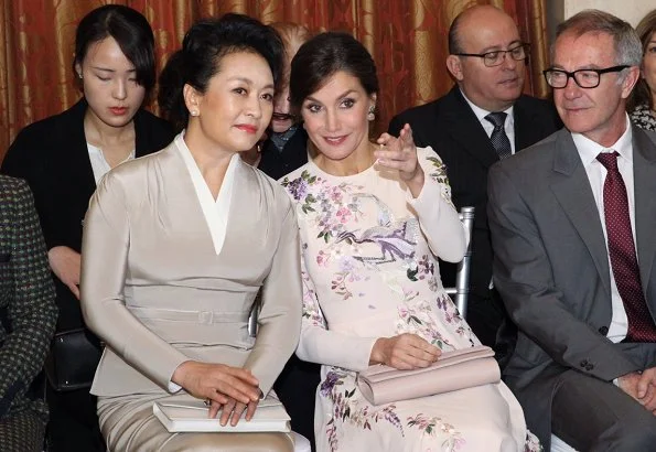 Queen Letizia wore ASOS DESIGN Tall midi dress with pretty floral and bird embroidery.  First Lady Peng Liyuan. Carolina Herrera coat
