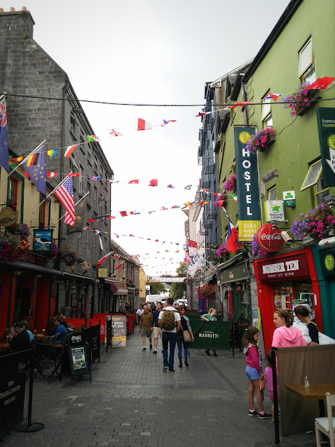 Exploring Galway city - colours and unexpected art by Annie Japaud flags, banners and crowds