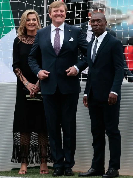 Queen Maxima and King Willem-Alexander attended a Football Clinic. Queen Maxima wore black long dress in Milan