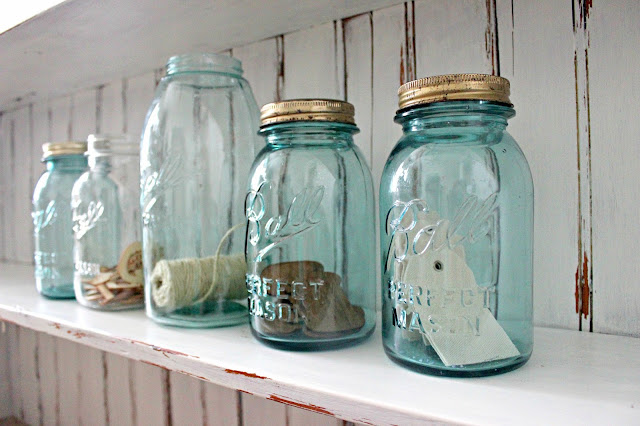 Blue mason jars and white, chippy distressed wood; a pair made in heaven.