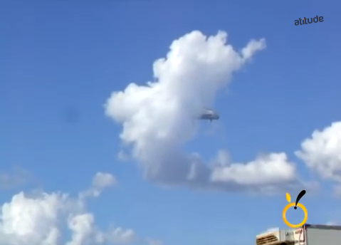 UFO emerging from a cloud