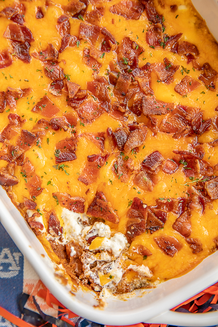 Cracked Out Bean Dip - SO addictive! Bean dip loaded with cheddar bacon and ranch. I could NOT stop eating this yummy dip. The flavors are amazing! Refried beans, taco seasoning, sour cream, ranch, bacon and cheddar cheese. Can make ahead of time and refrigerate until ready to bake. Serve with fritos and tortilla chips. This dip is always the first thing to go at our tailgates! I never have any leftovers! YUM! #dip #beandip #tailgating #appetizer #partyfood Cracked Out Bean Dip - SO addictive! Bean dip loaded with cheddar bacon and ranch. I could NOT stop eating this yummy dip. The flavors are amazing! Refried beans, taco seasoning, sour cream, ranch, bacon and cheddar cheese. Can make ahead of time and refrigerate until ready to bake. Serve with fritos and tortilla chips. This dip is always the first thing to go at our tailgates! I never have any leftovers! YUM! #dip #beandip #tailgating #appetizer #partyfood