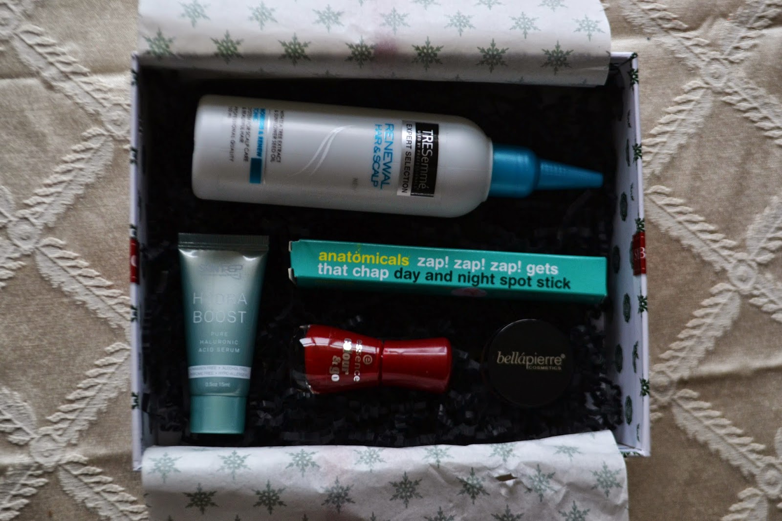 opening the december glossybox to see the products inside