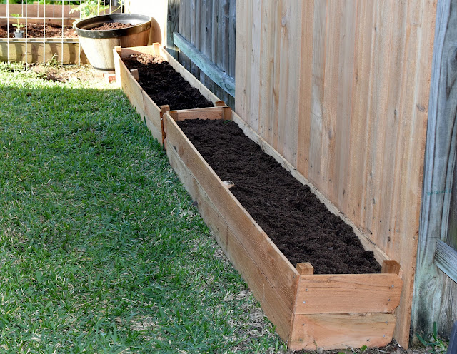 Two cedar picket raised beds with gardening soil, cow manure compost and perlite