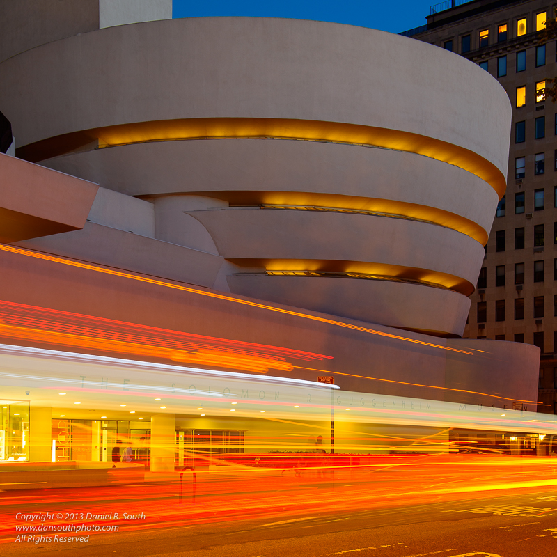 a photograph of the guggenheim museum new york with traffic trails