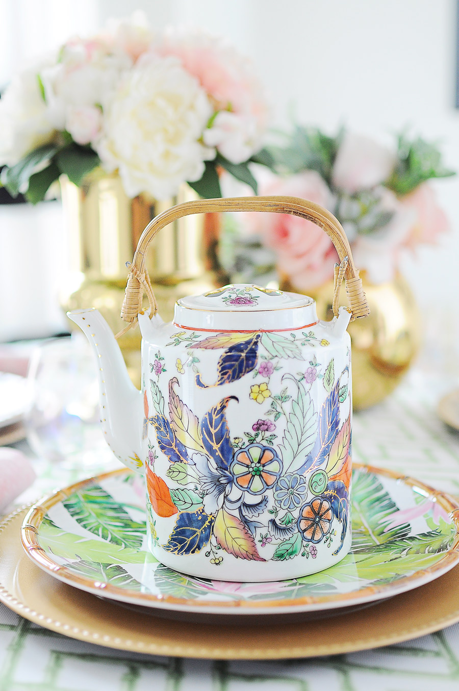 A gorgeous tobacco leaf teapot on a pink, green, white and gold chinoiserie inspired tablescape. A gorgeous tobacco leaf teapot on a pink, green, white and gold chinoiserie inspired tablescape.
