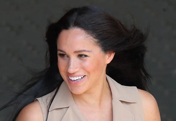 Meghan Markle wore a new double breasted trench dress by Banana Republic and legend suede pumps by Stuart Weitzman