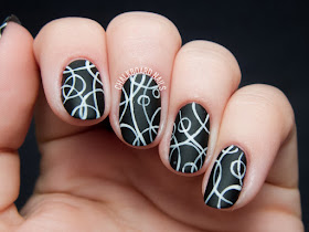 Encircled black and white nail art by @chalkboardnails