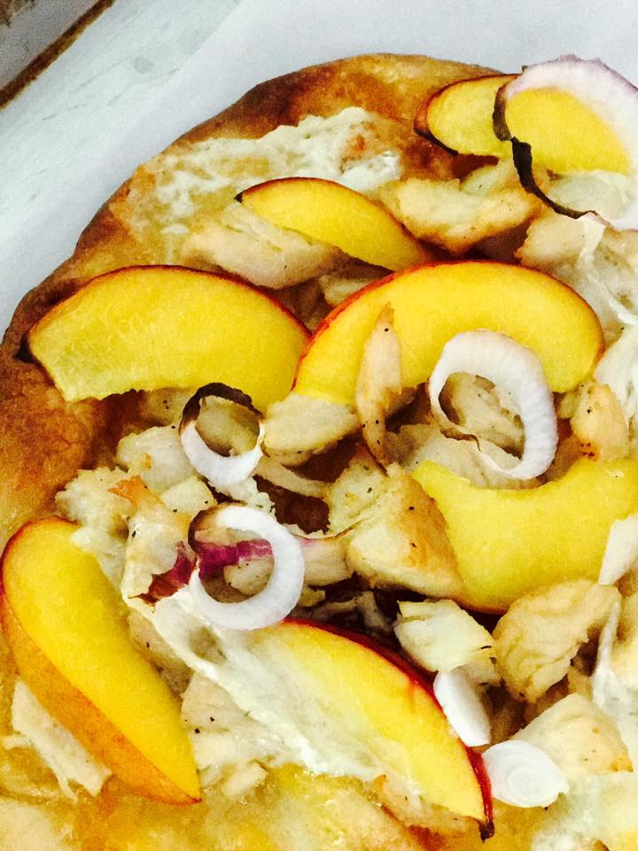Chicken, brie, and peach meddle together to create a fresh and unique flatbread.