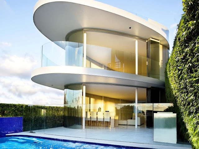 Modern house and the swimming pool with glass fence 