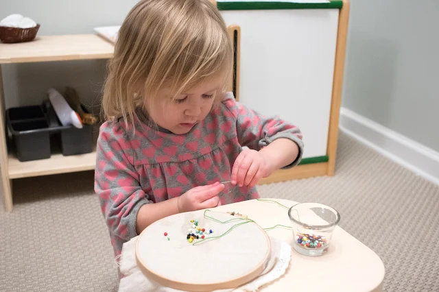 Montessori at home activity - bead sewing for a 3-year-old. 