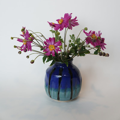 Beautiful ceramic pottery vase with flowers by Lily.