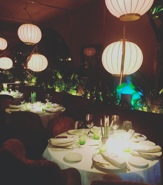 round tables and lights inside restaurant amazonico in madrid