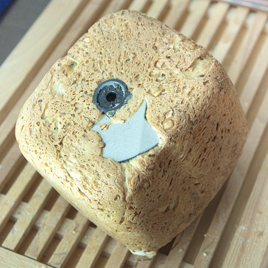 Bread with bread macine mixing blade stuck inside.