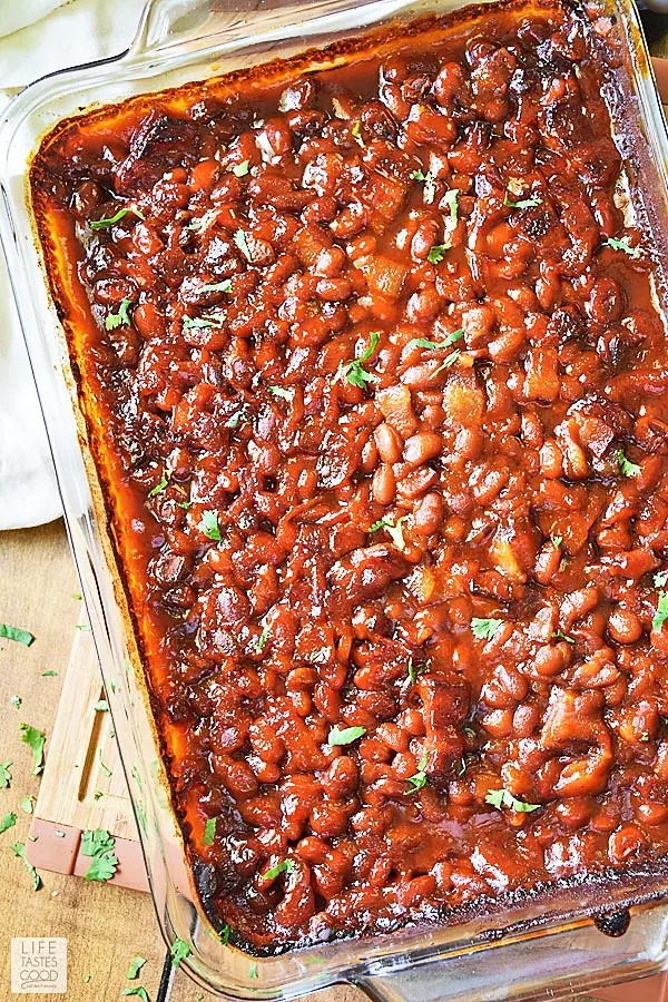 Cowboy Baked Beans on cutting board in baking dish ready to serve
