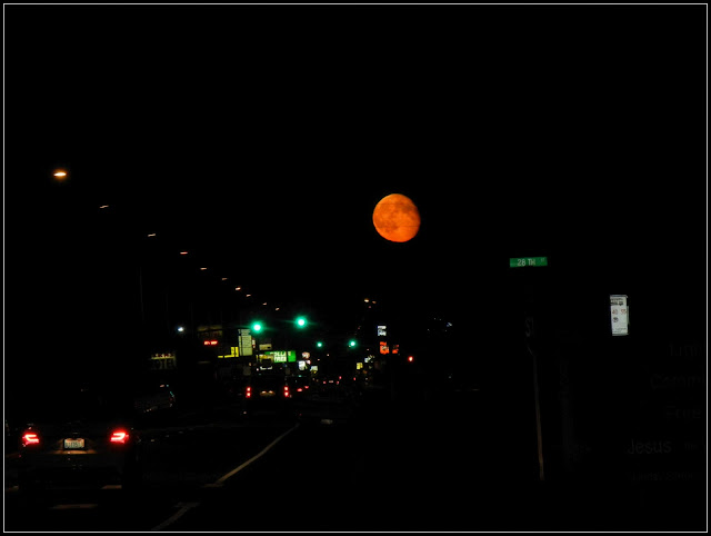 A large red moon over a main street in Aberdeen, Washington