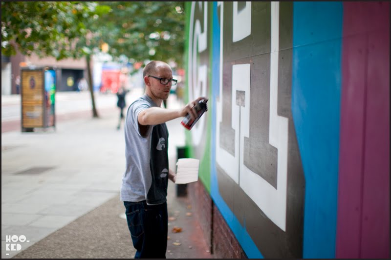 Street Artist Ben Eine at work on his Change Mural in London
