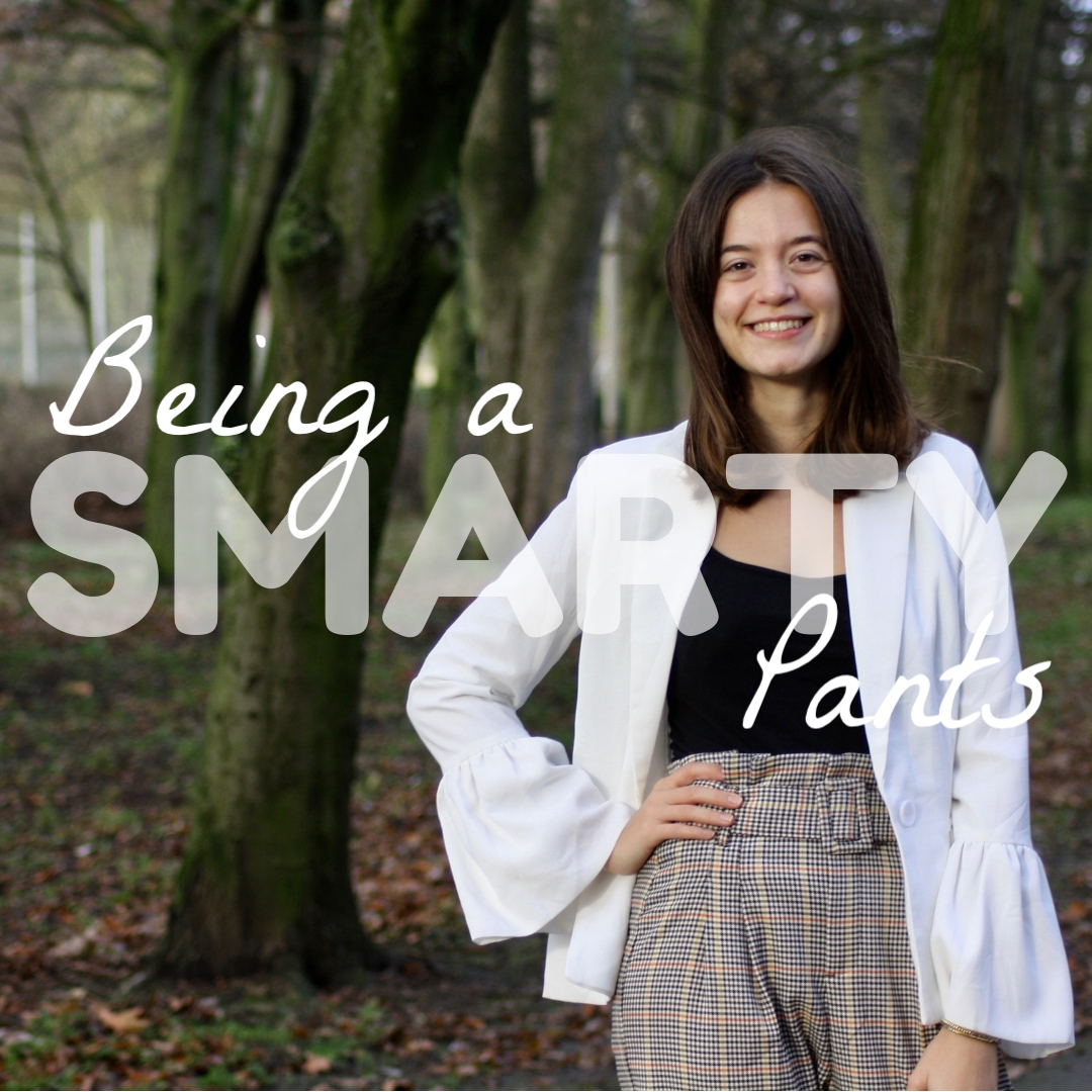 abbey, a brunette blogger, wears a white blazer and paperbag waist trousers