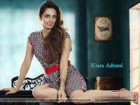 kiara advani wallpapers hot photo hd images bikini pics, sitting on table and showing off her sleekly legs with heels