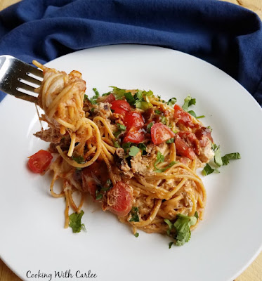 fork with twirled creamy bbq pulled pork spaghetti on it.