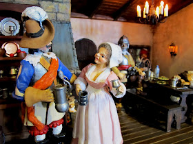 Two figures inside a one-twelfth scale miniature mid 17th-century inn.