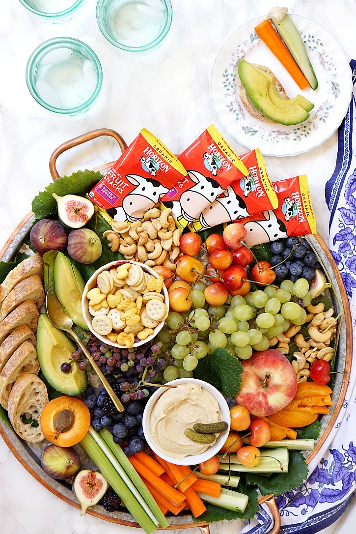Kid Friendly Snack Platter Ideas A big kid-friendly snack platter filled with fruit, veggies, hummus, crackers, nuts, and Horizon fruit snacks is perfect for any family party.