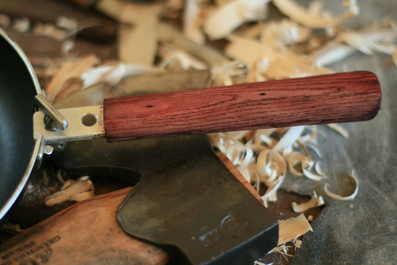 A frying pan with wooden folding handle