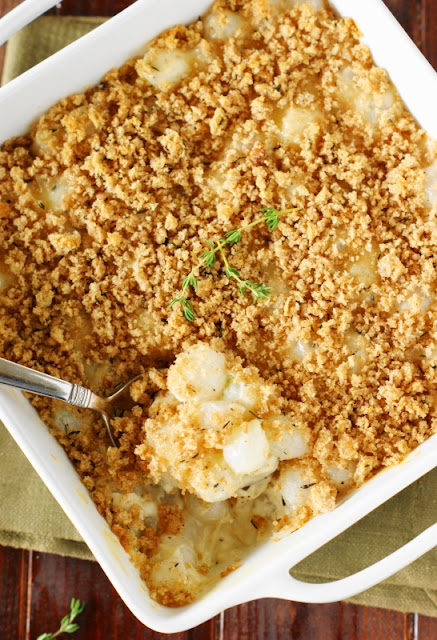 Creamed Pearl Onion Gratin ~ Tender pearl onions baked in creamy cheesy sauce, delicately seasoned with fresh thyme crumb topping. They're a perfect Thanksgiving or holiday side.  www.thekitchenismyplayground.com