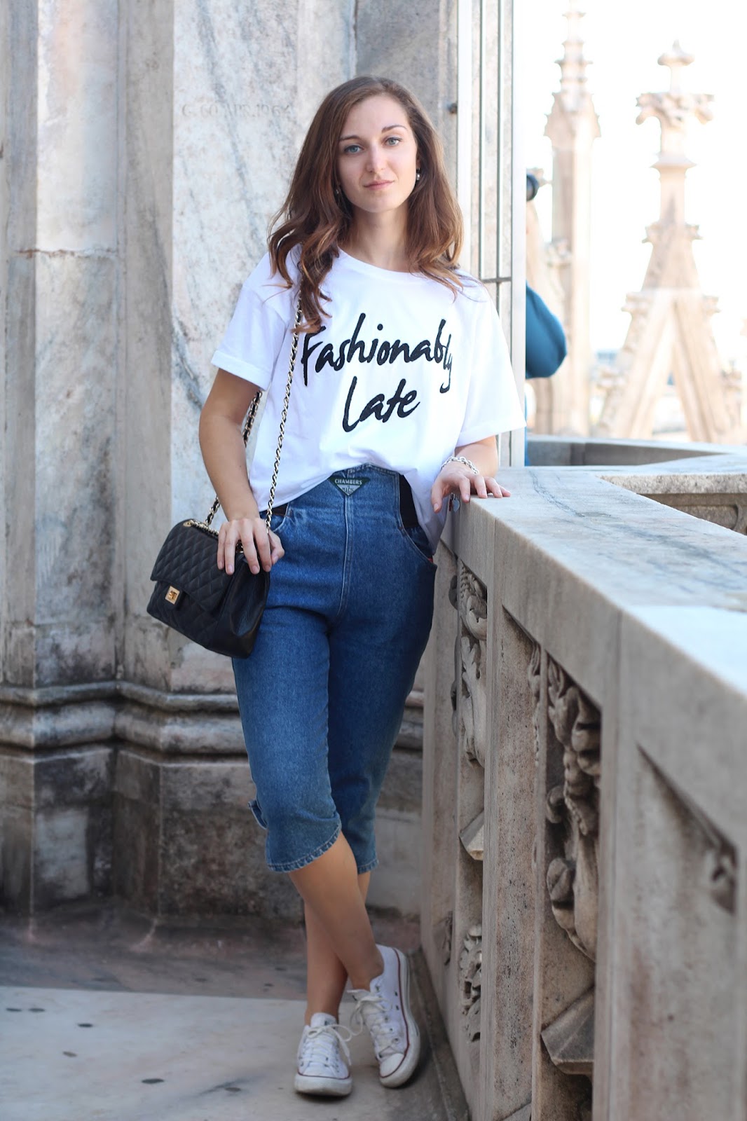 outfit comodo e alla moda in denim, converse, t-shirt bianca e tracolla Chanel 2.55