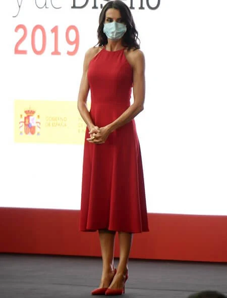 Queen Letizia wore a halter neckline red dress by Carolina Herrera, and nude patent leather slingback pumps, and animal print clutch