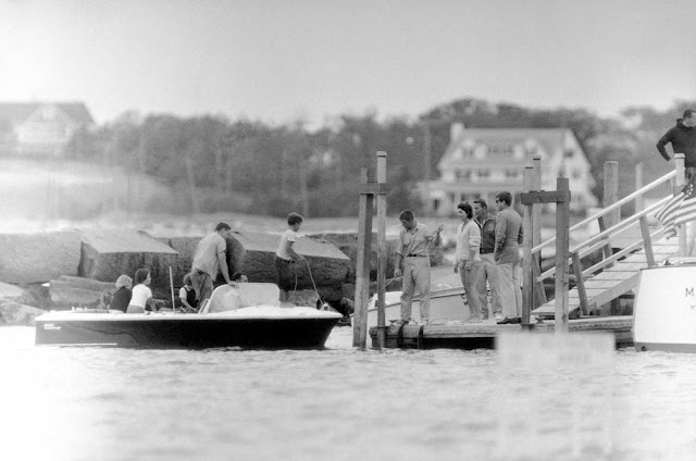 President John Kennedy, right, and his wife, Jacqueline, wearing bathing suit, stand on a pier after spending the afternoon boating on Nantucket Sound at Hyannis Port, Massachusetts, on August 5, 1961. The President and U.N. Ambassador Adlai E. Stevenson conferred aboard his yacht during the cruise.