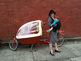 Olena Russell and child, with her beloved Bakfiets.
