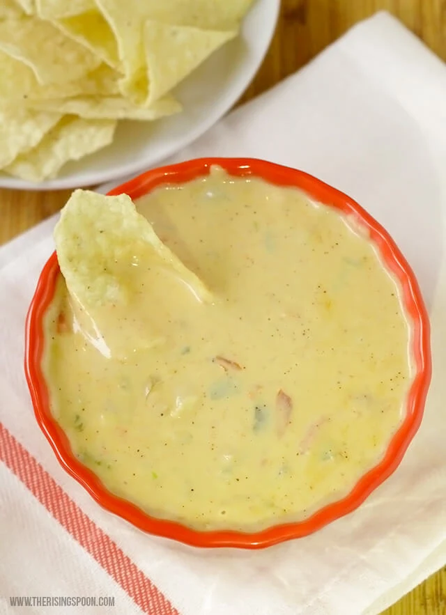 An easy homemade queso dip recipe made with three types of real cheese, onion, garlic, peppers, and spices in 30 minutes or less. Perfect for game day parties, holiday gatherings, or a relaxing night in!