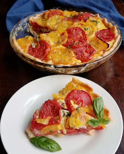 Like a tomato sandwich with mayo and cheese, but in pie form! This savory tomato pie is a must make summer recipe! slice of tomato pie with rest of pie in the background