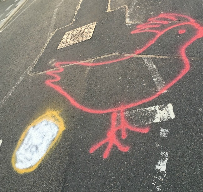 chicken-and-egg-spray-painted-onto-road-at-Llandough-Hospital