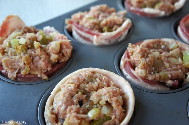 A close up of muffin tin with meatloaf lined with bacon in each muffin space.