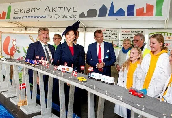 Crown Princess Mary officially opened Crown Princess Mary's Bridge in Roskilde.She is wearing blue coat and dolce Gabbana dress