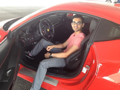 Neil-Patel-Posing-in-a-Red-Ferrari-sport-car
