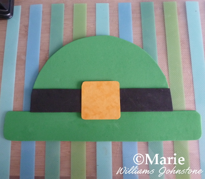 green paper hat with black buckle