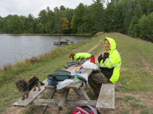 hikers eating lunch at a picnic table