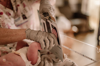 Nurse taking newborn foot prints - Morning Owl Fine Art Birth Photography San Diego