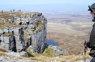 Cliff on mountain with walkers