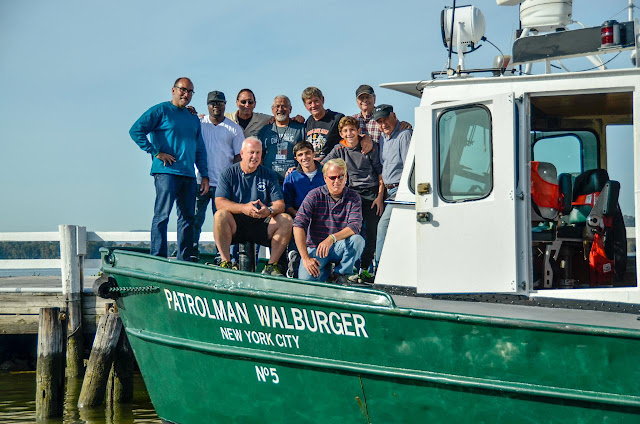 Large group of veterans gather for a picture on Launch 5 vessel.