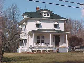 Photo of home after Roof Menders applied restoration green acrylic in 2004