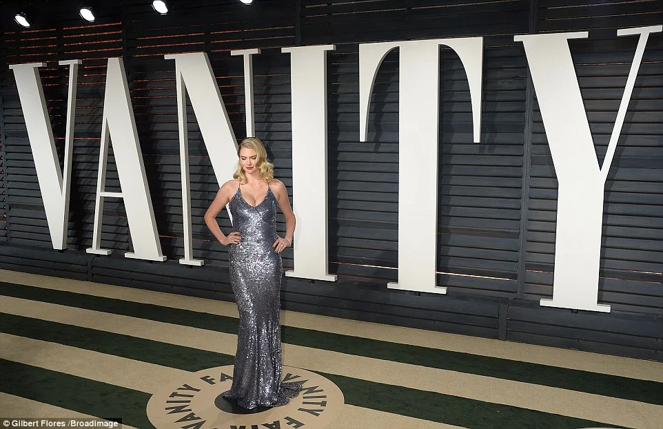 Kate Upton bares cleavage in a sequinned gown at the 2017 Vanity Fair Oscar Party